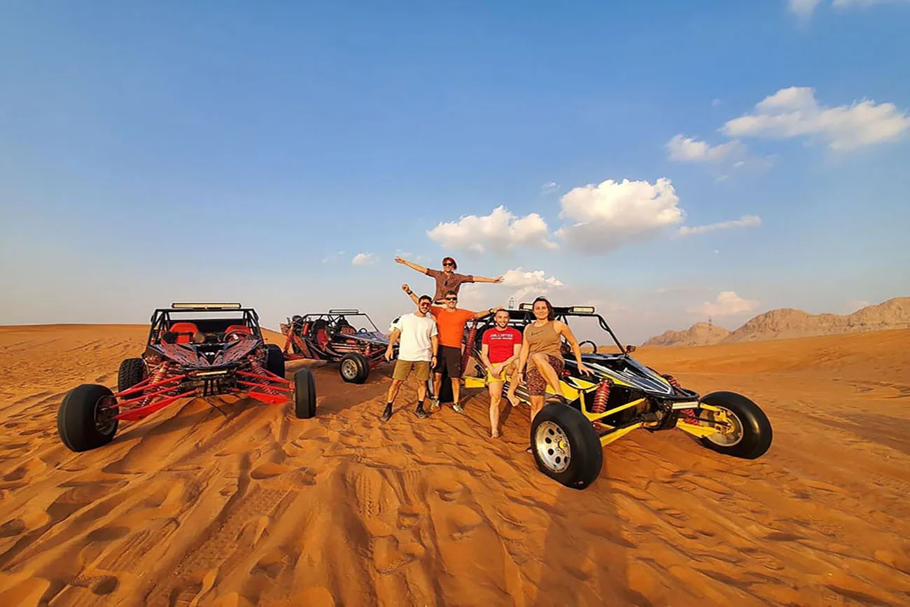 Guests gathered beside custom buggies in the desert