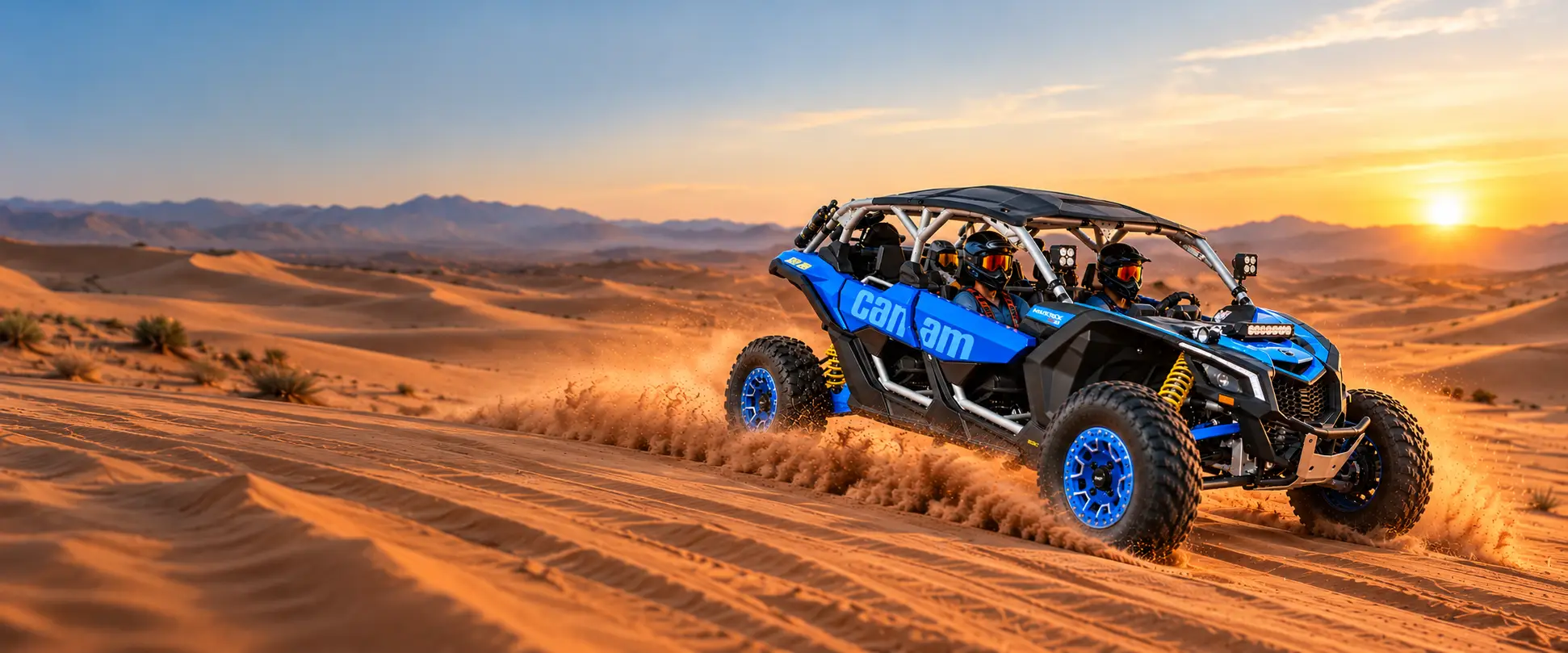 Blue buggy racing across the Lahbab dunes at sunset