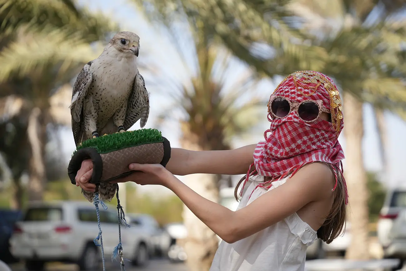 Guests posing with a falcon